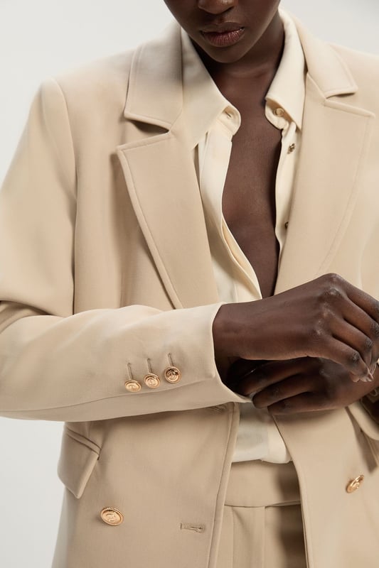 A sculptural rendition of the classic blazer, this piece offers endless sophistication. Sharp tailoring and double-breasted buttons create a cinched silhouette, while classic notched lapels and flap pockets add a traditional touch. Style this blazer with co-ordinating tailored trousers for a powerful ensemble, or size up for a contemporary, oversized aesthetic.Notched collarDouble breastedTailored Browse this seasons suits now.