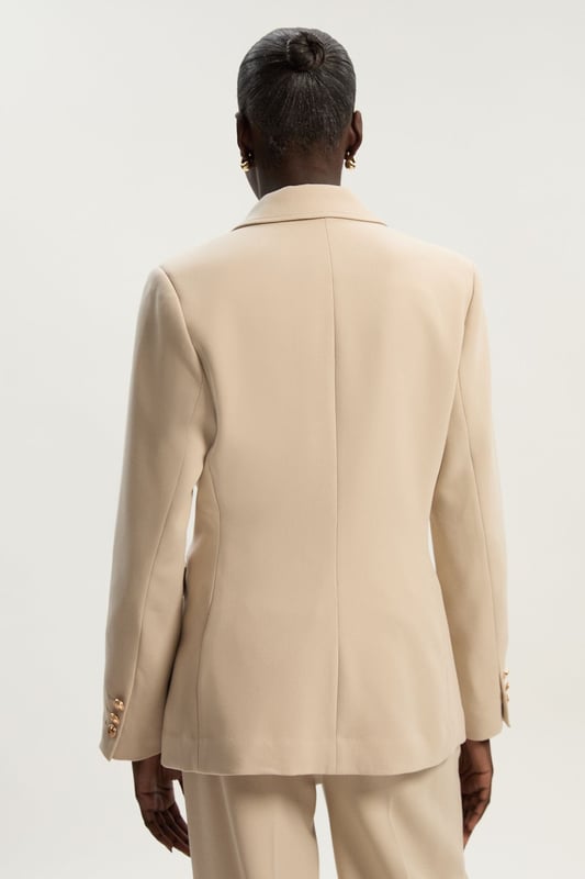 A sculptural rendition of the classic blazer, this piece offers endless sophistication. Sharp tailoring and double-breasted buttons create a cinched silhouette, while classic notched lapels and flap pockets add a traditional touch. Style this blazer with co-ordinating tailored trousers for a powerful ensemble, or size up for a contemporary, oversized aesthetic.Notched collarDouble breastedTailored Browse this seasons suits now.