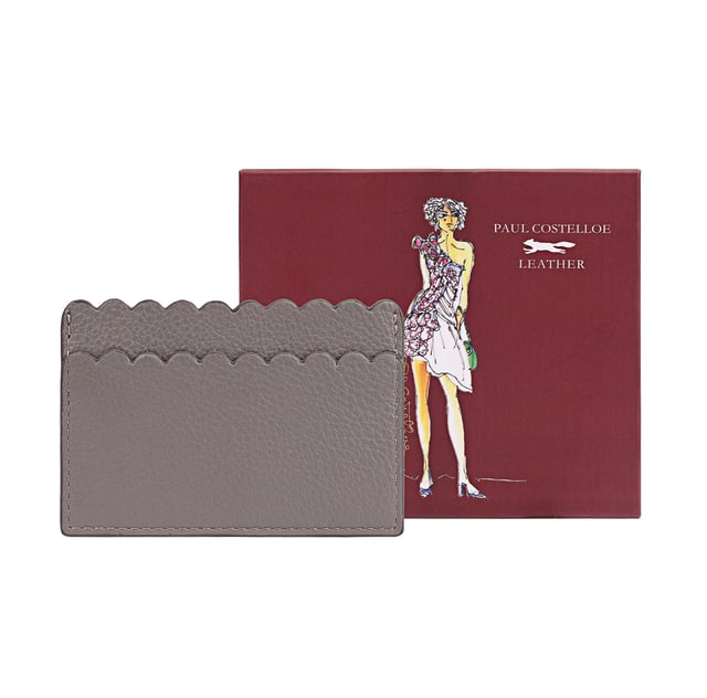 Introducing our Elegant Leather Card Holder, meticulously crafted from soft genuine leather. This stylish accessory features exquisite scallop detailing that adds a touch of sophistication. Perfectly designed to hold your travel or bank cards, this card holder is both practical and chic. It comes beautifully packaged in a gift box, making it an ideal gift for yourself or a loved one. Elevate your accessory game with this must-have item that combines functionality with elegance.