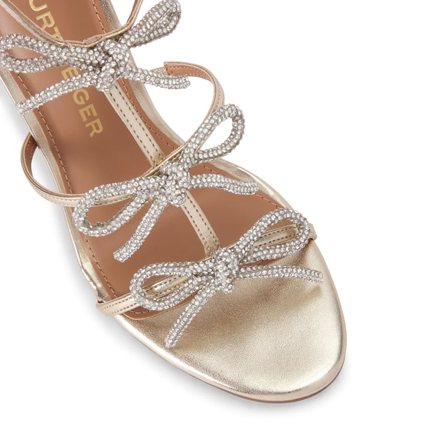 The KG Kurt Geiger Scarlet is a high heel with a metallic gold leather alternative upper and silver crystal bows across the caged upper. The heel is in a stiletto style. Heel height: 10.5cm.