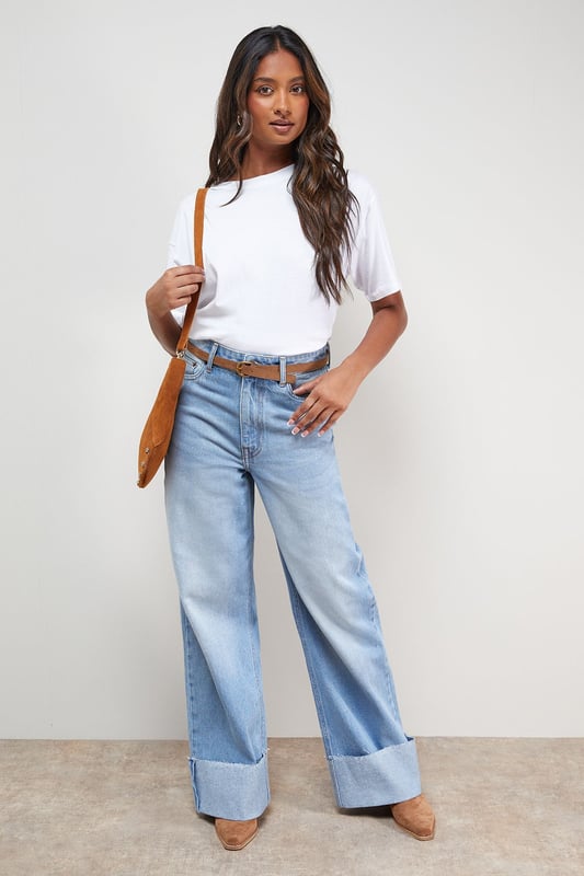 Distinctive turnup hem detail creates a contemporary silhouette
        Straight leg design offers a relaxed, comfortable fit
        High-rise waistband for a flattering shape
        Classic five-pocket styling with traditional stitching
        Wide leg opening with substantial cuff detail for a fashion-forward look
    
    These Oasis denim straight leg jeans combine timeless style with modern detailing. The relaxed fit and statement turnup hem create a fresh, contemporary look that's perfect for everyday wear. Style with a simple white tee and tan accessories for an effortlessly chic daytime ensemble, or pair with a floral blouse and ballet flats for weekend brunches and casual gatherings. The versatile straight leg silhouette works beautifully with both fitted and oversized tops, making these jeans a true wardrobe staple. For cooler days, layer with an oversized cardigan or denim jacket and trainers for a casual yet put-together look. The high-rise waist and relaxed fit through the leg ensure all-day comfort without compromising on style.