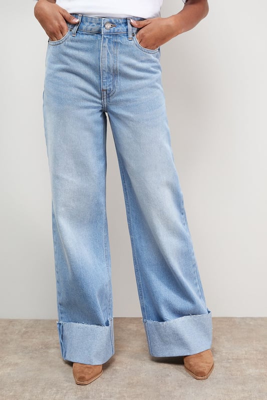 Distinctive turnup hem detail creates a contemporary silhouette
        Straight leg design offers a relaxed, comfortable fit
        High-rise waistband for a flattering shape
        Classic five-pocket styling with traditional stitching
        Wide leg opening with substantial cuff detail for a fashion-forward look
    
    These Oasis denim straight leg jeans combine timeless style with modern detailing. The relaxed fit and statement turnup hem create a fresh, contemporary look that's perfect for everyday wear. Style with a simple white tee and tan accessories for an effortlessly chic daytime ensemble, or pair with a floral blouse and ballet flats for weekend brunches and casual gatherings. The versatile straight leg silhouette works beautifully with both fitted and oversized tops, making these jeans a true wardrobe staple. For cooler days, layer with an oversized cardigan or denim jacket and trainers for a casual yet put-together look. The high-rise waist and relaxed fit through the leg ensure all-day comfort without compromising on style.