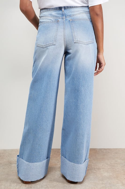 Distinctive turnup hem detail creates a contemporary silhouette
        Straight leg design offers a relaxed, comfortable fit
        High-rise waistband for a flattering shape
        Classic five-pocket styling with traditional stitching
        Wide leg opening with substantial cuff detail for a fashion-forward look
    
    These Oasis denim straight leg jeans combine timeless style with modern detailing. The relaxed fit and statement turnup hem create a fresh, contemporary look that's perfect for everyday wear. Style with a simple white tee and tan accessories for an effortlessly chic daytime ensemble, or pair with a floral blouse and ballet flats for weekend brunches and casual gatherings. The versatile straight leg silhouette works beautifully with both fitted and oversized tops, making these jeans a true wardrobe staple. For cooler days, layer with an oversized cardigan or denim jacket and trainers for a casual yet put-together look. The high-rise waist and relaxed fit through the leg ensure all-day comfort without compromising on style.
