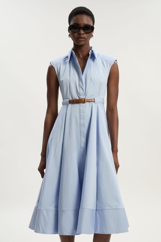 This Karen Millen collared midi dress combines timeless sophistication with practical daywear comfort. The structured silhouette features thoughtful pleating that creates a flattering A-line shape, whilst the included belt cinches the waist for a customised fit. Style with flat sandals and a woven tote for weekend brunches, or dress it up with ballet flats and a cardigan for family gatherings. The cotton fabric ensures this piece remains a comfortable choice for all-day wear, making it an essential addition to your casual-stylish wardrobe.  Crafted from pure cotton for breathable comfort Tailored silhouette with structured collar and cap sleeves Matching belt with gold-tone buckle Full midi skirt with pleating detail Button-through front design
