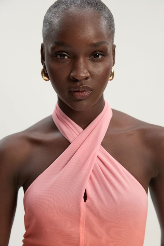 This eye-catching Karen Millen bodysuit combines contemporary design with effortless wearability. The cross halter neckline frames the decolletage beautifully, whilst the ombre mesh effect creates visual interest that catches the light as you move. Style with wide-leg trousers as shown for a balanced silhouette that's perfect for summer gatherings or casual brunches. The jersey fabric offers comfortable stretch that moulds to your shape without feeling restrictive. For daytime events, pair with tailored shorts and flat sandals, or dress up with a flowing midi skirt and statement earrings for evening drinks. Layer with a lightweight blazer when temperatures drop for a look that transitions seamlessly from day to night. This versatile piece works wonderfully for family celebrations or casual meet-ups with friends.  Striking cross halter neckline creating an elegant silhouette Captivating ombre mesh design Figure-enhancing jersey bodysuit with comfortable stretch Sleek open back design Secure halterneck fastening