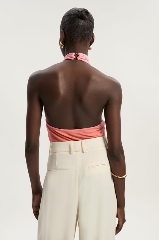 This eye-catching Karen Millen bodysuit combines contemporary design with effortless wearability. The cross halter neckline frames the decolletage beautifully, whilst the ombre mesh effect creates visual interest that catches the light as you move. Style with wide-leg trousers as shown for a balanced silhouette that's perfect for summer gatherings or casual brunches. The jersey fabric offers comfortable stretch that moulds to your shape without feeling restrictive. For daytime events, pair with tailored shorts and flat sandals, or dress up with a flowing midi skirt and statement earrings for evening drinks. Layer with a lightweight blazer when temperatures drop for a look that transitions seamlessly from day to night. This versatile piece works wonderfully for family celebrations or casual meet-ups with friends.  Striking cross halter neckline creating an elegant silhouette Captivating ombre mesh design Figure-enhancing jersey bodysuit with comfortable stretch Sleek open back design Secure halterneck fastening