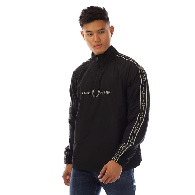 Mens Fred Perry Taped Sleeve Shell Jacket in black.- Stand-up collar.- Hal zip fastening.- Taped sleeve.- Embroidered logo on chest.- Elasticated cuffs and hem.- Slim fit.- Body: 100% Polyamide. Trim: 100% Polyester.- Ref: J4561102
