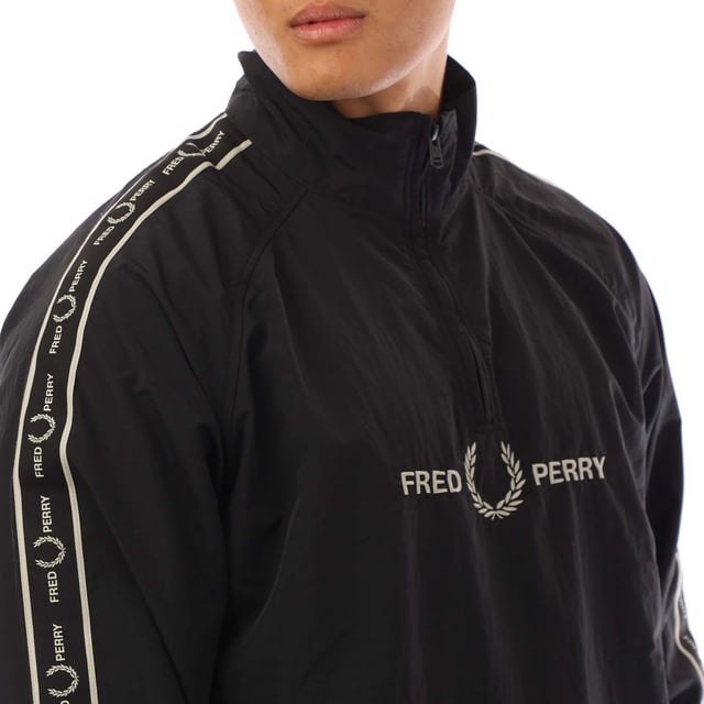 Mens Fred Perry Taped Sleeve Shell Jacket in black.- Stand-up collar.- Hal zip fastening.- Taped sleeve.- Embroidered logo on chest.- Elasticated cuffs and hem.- Slim fit.- Body: 100% Polyamide. Trim: 100% Polyester.- Ref: J4561102