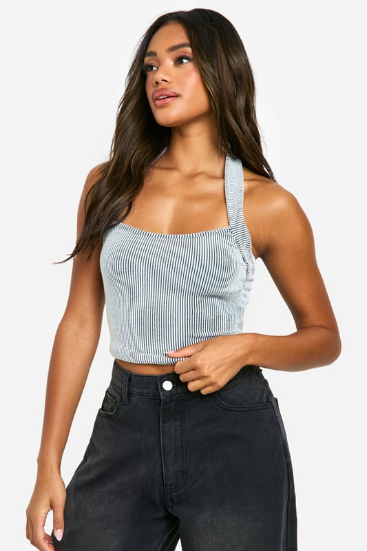 Ribbed jersey fabric for a comfortable, form-fitting look
        Halterneck design with a trendy crop length
        Sleeveless style perfect for warmer days
        Versatile piece that can be dressed up or down
        Figure-hugging silhouette to accentuate your curves
    
    This ribbed neckholder crop top is a must-have addition to your casual wardrobe. The halterneck design adds a touch of allure, while the cropped length allows you to show off just the right amount of skin. Perfect for those laid-back summer days or casual outings with friends, this top can be effortlessly styled for various occasions. Pair it with high-waisted wide-leg trousers and trainers for a relaxed daytime look, or dress it up with a midi skirt and strappy sandals for an evening out. The ribbed jersey fabric ensures a snug fit that moves with you, making it ideal for family gatherings or casual events where comfort is key. Layer it under a denim jacket or an oversized blazer when the temperature drops, proving its versatility as a year-round staple in your fashion arsenal.