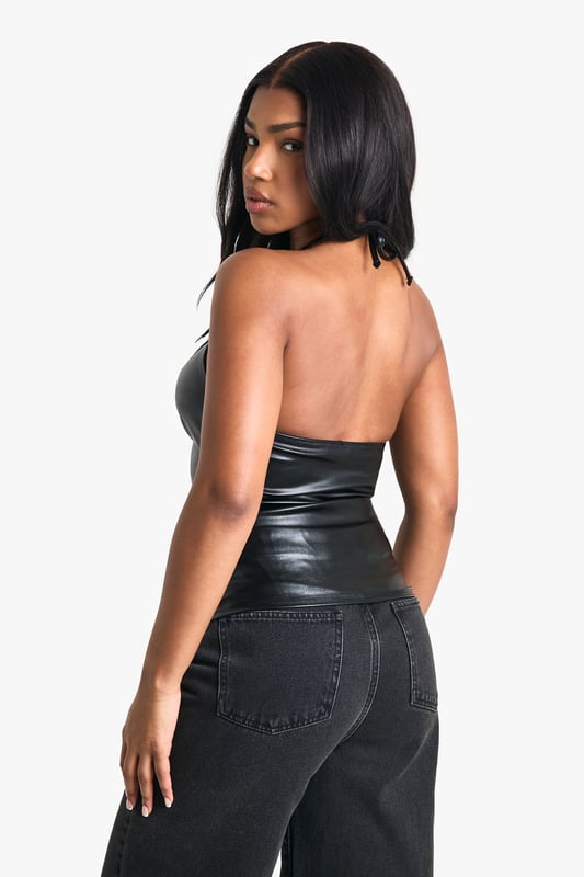 Sleek PU halterneck design for a bold, edgy look
        Eye-catching floral detail at the neckline adds a feminine touch
        Daring keyhole cutout enhances the allure
        Figure-hugging silhouette with ruched detailing
        Backless style for a show-stopping effect
    
    Make a statement on your next night out with this striking PU neckholder top. The sleek, figure-hugging design is perfect for those who want to turn heads and exude confidence. Style it with high-waisted wide-leg trousers and strappy heels for a chic ensemble that's ready for the club scene. The unique floral detail at the neckline adds an unexpected twist to the edgy look, while the daring keyhole cutout and backless design ensure you'll stand out in the crowd. For a more casual approach, pair it with your favourite jeans and a leather jacket. This versatile piece is a must-have for the fashion-forward woman who loves to experiment with her style and isn't afraid to make a bold impression.