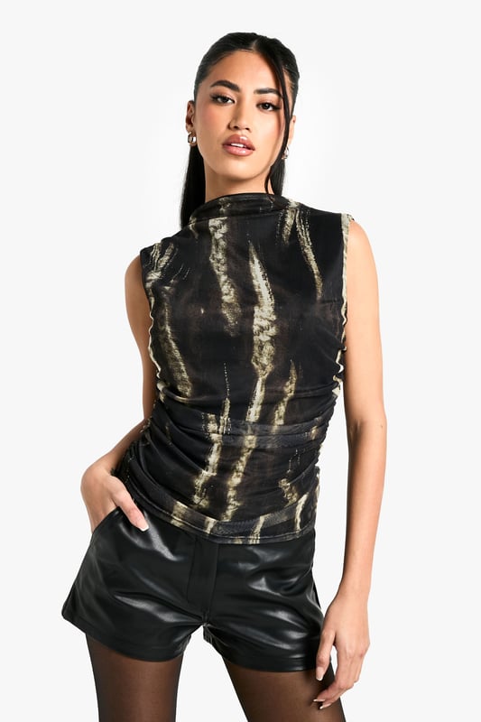 Striking animal print mesh fabric
        Flattering Bardot neckline
        Sleeveless design for a sultry look
        Ruched front detailing for added texture
        Figure-hugging silhouette
    
    Make a statement on your next night out with this eye-catching animal print Bardot top. The mesh fabric adds a touch of allure, whilst the ruched front detailing creates a flattering silhouette that's sure to turn heads. Perfect for those who love to stand out from the crowd, this top can be styled with leather-look shorts and knee-high boots for a bold, edgy ensemble. Alternatively, pair it with high-waisted trousers and strappy heels for a more sophisticated look. Whether you're hitting the club or meeting friends for drinks, this versatile piece will ensure you're always dressed to impress. Add some statement earrings and a clutch bag to complete your show-stopping outfit.
