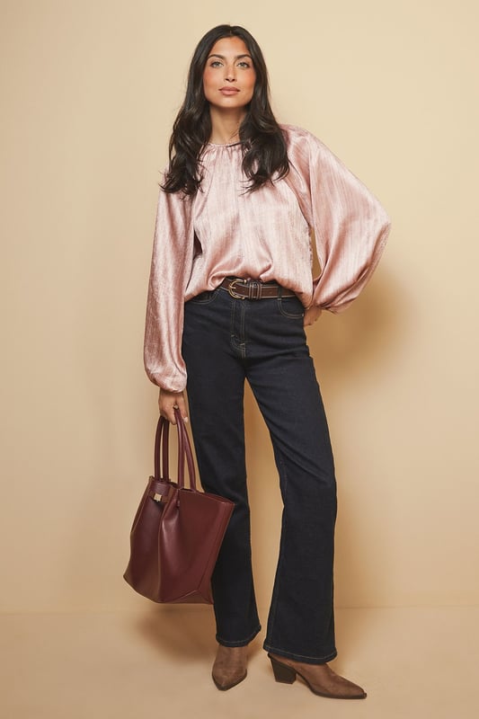 Luxurious shimmer satin blouse with elegant gathered neckline detail
        Voluminous balloon sleeves with fitted cuffs for a dramatic silhouette
        Relaxed fit through the body offering comfortable wear for all-day events
        Crew neckline with subtle pleating that catches the light beautifully
        Versatile design that transitions effortlessly from day to evening occasions
    
    This captivating Shimmer Satin Blouse from Wallis radiates sophistication with its lustrous finish and considered design details. The gathered crew neckline creates a flattering frame for statement jewellery, whilst the sumptuous balloon sleeves add a touch of drama to your ensemble. Style as shown with wide-leg trousers and a structured handbag for an elegant workwear look, or pair with a tailored pencil skirt and heels for formal occasions such as weddings or race days. The fluid drape of the fabric moves gracefully with you, ensuring you feel as confident as you look. For evening events, complement with statement earrings and a clutch bag to showcase the blouse's light-reflecting qualities. This versatile piece works beautifully layered under tailored blazers for a refined approach to occasion dressing.