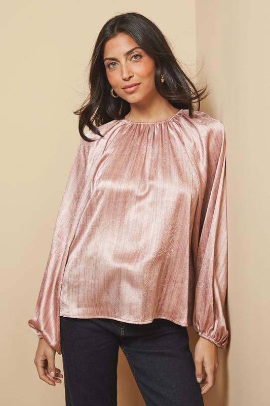 Luxurious shimmer satin blouse with elegant gathered neckline detail
        Voluminous balloon sleeves with fitted cuffs for a dramatic silhouette
        Relaxed fit through the body offering comfortable wear for all-day events
        Crew neckline with subtle pleating that catches the light beautifully
        Versatile design that transitions effortlessly from day to evening occasions
    
    This captivating Shimmer Satin Blouse from Wallis radiates sophistication with its lustrous finish and considered design details. The gathered crew neckline creates a flattering frame for statement jewellery, whilst the sumptuous balloon sleeves add a touch of drama to your ensemble. Style as shown with wide-leg trousers and a structured handbag for an elegant workwear look, or pair with a tailored pencil skirt and heels for formal occasions such as weddings or race days. The fluid drape of the fabric moves gracefully with you, ensuring you feel as confident as you look. For evening events, complement with statement earrings and a clutch bag to showcase the blouse's light-reflecting qualities. This versatile piece works beautifully layered under tailored blazers for a refined approach to occasion dressing.