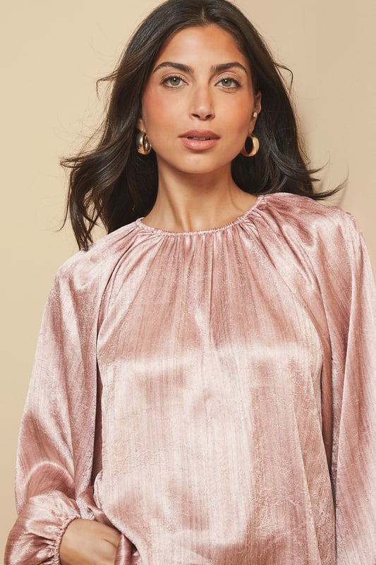 Luxurious shimmer satin blouse with elegant gathered neckline detail
        Voluminous balloon sleeves with fitted cuffs for a dramatic silhouette
        Relaxed fit through the body offering comfortable wear for all-day events
        Crew neckline with subtle pleating that catches the light beautifully
        Versatile design that transitions effortlessly from day to evening occasions
    
    This captivating Shimmer Satin Blouse from Wallis radiates sophistication with its lustrous finish and considered design details. The gathered crew neckline creates a flattering frame for statement jewellery, whilst the sumptuous balloon sleeves add a touch of drama to your ensemble. Style as shown with wide-leg trousers and a structured handbag for an elegant workwear look, or pair with a tailored pencil skirt and heels for formal occasions such as weddings or race days. The fluid drape of the fabric moves gracefully with you, ensuring you feel as confident as you look. For evening events, complement with statement earrings and a clutch bag to showcase the blouse's light-reflecting qualities. This versatile piece works beautifully layered under tailored blazers for a refined approach to occasion dressing.