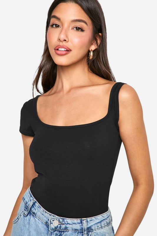 Asymmetric neckline for a unique twist
        One short sleeve and one sleeveless design
        Figure-hugging bodysuit silhouette
        Soft cotton-elastane blend for comfort and stretch
        Versatile piece for layering or wearing alone
    
    Make a statement with this eye-catching asymmetrical bodysuit from Boohoo. The distinctive design features a single short sleeve and an asymmetric neckline, creating a bold and modern look. Perfect for the fashion-forward woman who loves to stand out, this bodysuit can be styled for various occasions. Pair it with high-waisted jeans and trainers for a casual daytime ensemble, or dress it up with a sleek midi skirt and heels for evening drinks. The figure-hugging silhouette flatters your curves, while the cotton-elastane fabric ensures all-day comfort. Layer it under a blazer for a chic office look or wear it solo on warmer days. This versatile piece is a must-have addition to any trendsetter's wardrobe, offering endless styling possibilities for the young woman who wants to stay ahead of the fashion curve.