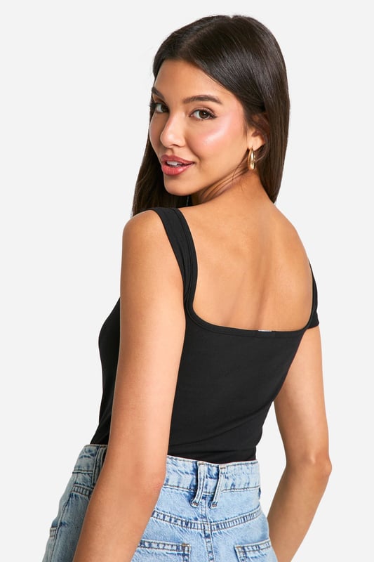 Asymmetric neckline for a unique twist
        One short sleeve and one sleeveless design
        Figure-hugging bodysuit silhouette
        Soft cotton-elastane blend for comfort and stretch
        Versatile piece for layering or wearing alone
    
    Make a statement with this eye-catching asymmetrical bodysuit from Boohoo. The distinctive design features a single short sleeve and an asymmetric neckline, creating a bold and modern look. Perfect for the fashion-forward woman who loves to stand out, this bodysuit can be styled for various occasions. Pair it with high-waisted jeans and trainers for a casual daytime ensemble, or dress it up with a sleek midi skirt and heels for evening drinks. The figure-hugging silhouette flatters your curves, while the cotton-elastane fabric ensures all-day comfort. Layer it under a blazer for a chic office look or wear it solo on warmer days. This versatile piece is a must-have addition to any trendsetter's wardrobe, offering endless styling possibilities for the young woman who wants to stay ahead of the fashion curve.