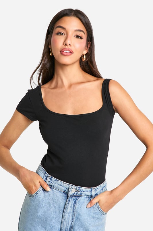 Asymmetric neckline for a unique twist
        One short sleeve and one sleeveless design
        Figure-hugging bodysuit silhouette
        Soft cotton-elastane blend for comfort and stretch
        Versatile piece for layering or wearing alone
    
    Make a statement with this eye-catching asymmetrical bodysuit from Boohoo. The distinctive design features a single short sleeve and an asymmetric neckline, creating a bold and modern look. Perfect for the fashion-forward woman who loves to stand out, this bodysuit can be styled for various occasions. Pair it with high-waisted jeans and trainers for a casual daytime ensemble, or dress it up with a sleek midi skirt and heels for evening drinks. The figure-hugging silhouette flatters your curves, while the cotton-elastane fabric ensures all-day comfort. Layer it under a blazer for a chic office look or wear it solo on warmer days. This versatile piece is a must-have addition to any trendsetter's wardrobe, offering endless styling possibilities for the young woman who wants to stay ahead of the fashion curve.