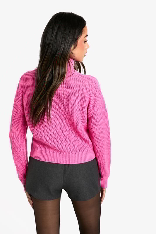 Cosy roll neck design for ultimate comfort
        Ribbed knit texture adds visual interest
        Cropped length for a modern silhouette
        Relaxed fit through the body for easy layering
        Versatile style suitable for various casual occasions
    
    This short basic roll neck jumper is a must-have addition to your casual wardrobe. The ribbed knit texture not only adds a touch of visual intrigue but also ensures warmth during cooler days. Its cropped length makes it perfect for pairing with high-waisted bottoms, creating a balanced and contemporary look. As seen on the model, try styling it with tailored shorts and sheer tights for an edgy twist on casual wear. For a more laid-back ensemble, pair it with your favourite jeans and trainers. The relaxed fit allows for easy layering, making it ideal for family gatherings or casual outings with friends. Whether you're heading to a coffee shop or a casual dinner, this jumper offers both style and comfort, embodying the Boohoo ethos of accessible fashion for the trend-conscious young woman.