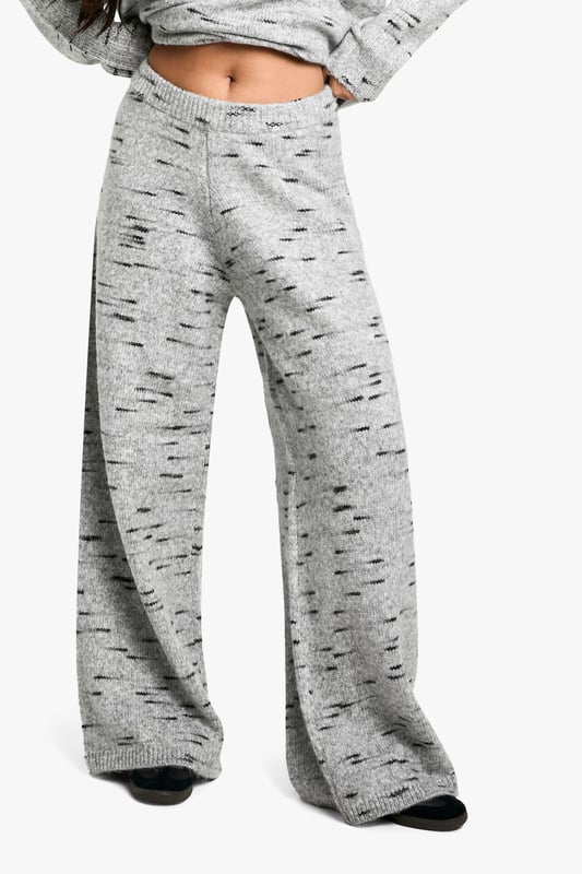 Wide-leg knit trousers for ultimate comfort
        Textured fabric with a unique speckled pattern
        High-waisted design for a flattering silhouette
        Relaxed fit through the legs for easy movement
        Versatile style suitable for various casual occasions
    
    Embrace laid-back chic with these wide-leg knit trousers from Boohoo. The textured fabric features an eye-catching speckled pattern, adding visual interest to your casual ensemble. The high-waisted design creates a sleek silhouette, while the relaxed fit through the legs ensures all-day comfort. Perfect for lazy weekends or casual outings, these trousers can be effortlessly styled with a cropped hoodie and trainers for a trendy look. For a more put-together appearance, pair them with a fitted turtleneck and ankle boots. The versatility of these trousers makes them a must-have addition to your wardrobe, suitable for family gatherings, coffee dates with friends, or simply lounging at home in style. Customise your look by rolling up the hems or leaving them long to create different vibes for various occasions.