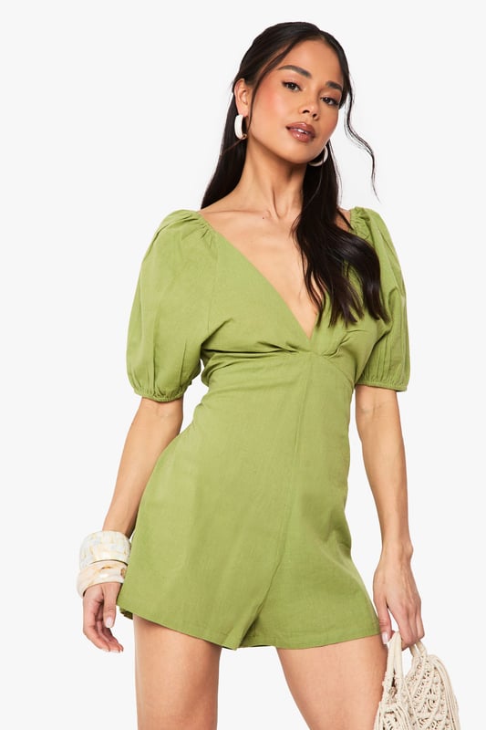 Crafted from a breathable linen mix fabric, perfect for warm-weather occasions
        Featuring charming puff sleeves for a feminine, on-trend silhouette
        Flattering V-neckline frames the dcolletage beautifully
        Striking open back design with delicate tie detail for added interest
        Relaxed fit shorts provide comfort whilst maintaining a stylish appearance
    
    This delightful linen mix playsuit combines comfort with effortless style for your casual wardrobe. The feminine puff sleeves create a romantic silhouette, while the plunging V-neckline adds a touch of allure. The standout feature is undoubtedly the open back with tie detailing, creating visual interest when you turn around. Style with flat sandals and a woven bag, as shown on our model, for daytime gatherings or family brunches. For a more polished look, add statement earrings and metallic accessories. The versatile design works brilliantly for garden parties, seaside holidays or casual weekend outings. The breathable fabric ensures you'll stay comfortable throughout the day, making this playsuit a summer wardrobe essential that delivers both practicality and style in equal measure.