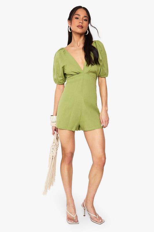 Crafted from a breathable linen mix fabric, perfect for warm-weather occasions
        Featuring charming puff sleeves for a feminine, on-trend silhouette
        Flattering V-neckline frames the dcolletage beautifully
        Striking open back design with delicate tie detail for added interest
        Relaxed fit shorts provide comfort whilst maintaining a stylish appearance
    
    This delightful linen mix playsuit combines comfort with effortless style for your casual wardrobe. The feminine puff sleeves create a romantic silhouette, while the plunging V-neckline adds a touch of allure. The standout feature is undoubtedly the open back with tie detailing, creating visual interest when you turn around. Style with flat sandals and a woven bag, as shown on our model, for daytime gatherings or family brunches. For a more polished look, add statement earrings and metallic accessories. The versatile design works brilliantly for garden parties, seaside holidays or casual weekend outings. The breathable fabric ensures you'll stay comfortable throughout the day, making this playsuit a summer wardrobe essential that delivers both practicality and style in equal measure.