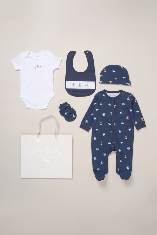 Surprise new parents with the printed 5-Piece baby gift Set from Rock A Bye Baby Boutique. This thoughtful bundle includes a cosy matching all-in-one, bodysuit, bib, hat, and mitts for essential wardrobe pieces. Crafted from 100% cotton, each item ensures their baby stays stylish and snug, perfect for everyday wear or special occasions. Packaged elegantly in a mesh bag.