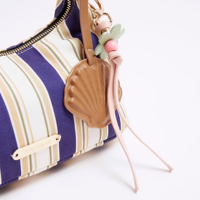 River Island Womens Blue Canvas Striped Charm Shoulder Bag Canvas fabric, Striped print, Charm detail, Metal gold RI hardware, Grab handles, Adjustable strap, Zip fastening, Strap length: 14cm, Bag dimensions H: 13cm x D: 26cm x W: 12cmAbout the brandFASHION IS OUR DNARiver Island is an icon of the British high street. Inspired by the latest trends and our heritage style archives, we've been serving style and leading trends for over sixty years.We make fashion for real people with real lives, who want to look real good. Because life's a celebration - let's dress for it.