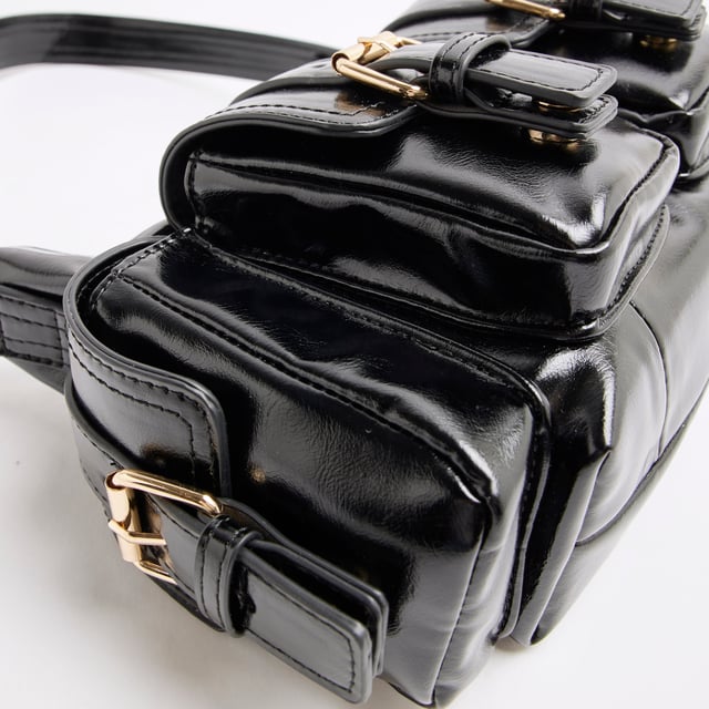 River Island Womens Black Buckle Pocket Utility Shoulder Bag Faux leather, Patent, Shoulder strap, Pocket detail, Gold hardware, Interior pocket, Zip fastening, Handle drop: 25cm, H: 15cm x W: 25cm x D: 8cmAbout the brandFASHION IS OUR DNARiver Island is an icon of the British high street. Inspired by the latest trends and our heritage style archives, we've been serving style and leading trends for over sixty years.We make fashion for real people with real lives, who want to look real good. Because life's a celebration - let's dress for it.