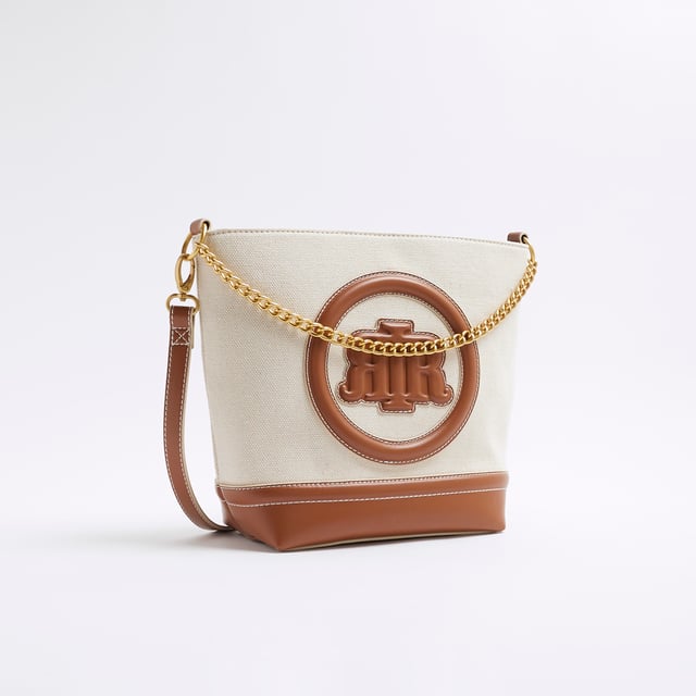 River Island Womens Cream Canvas Bucket Bag Canvas fabric, RR pendant, Lock detail, Stud pressed fastening, Grab handle, Bag dimension: H: 26cm x D: 12cm x W: 30cmAbout the brandFASHION IS OUR DNARiver Island is an icon of the British high street. Inspired by the latest trends and our heritage style archives, we've been serving style and leading trends for over sixty years.We make fashion for real people with real lives, who want to look real good. Because life's a celebration - let's dress for it.
