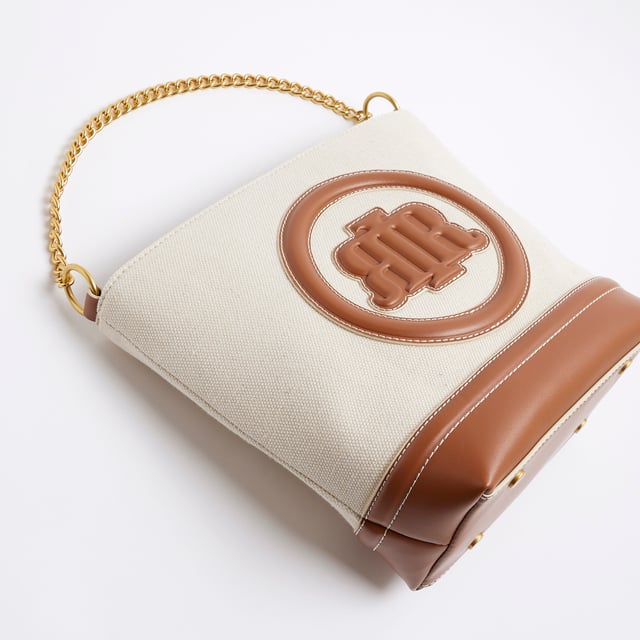 River Island Womens Cream Canvas Bucket Bag Canvas fabric, RR pendant, Lock detail, Stud pressed fastening, Grab handle, Bag dimension: H: 26cm x D: 12cm x W: 30cmAbout the brandFASHION IS OUR DNARiver Island is an icon of the British high street. Inspired by the latest trends and our heritage style archives, we've been serving style and leading trends for over sixty years.We make fashion for real people with real lives, who want to look real good. Because life's a celebration - let's dress for it.