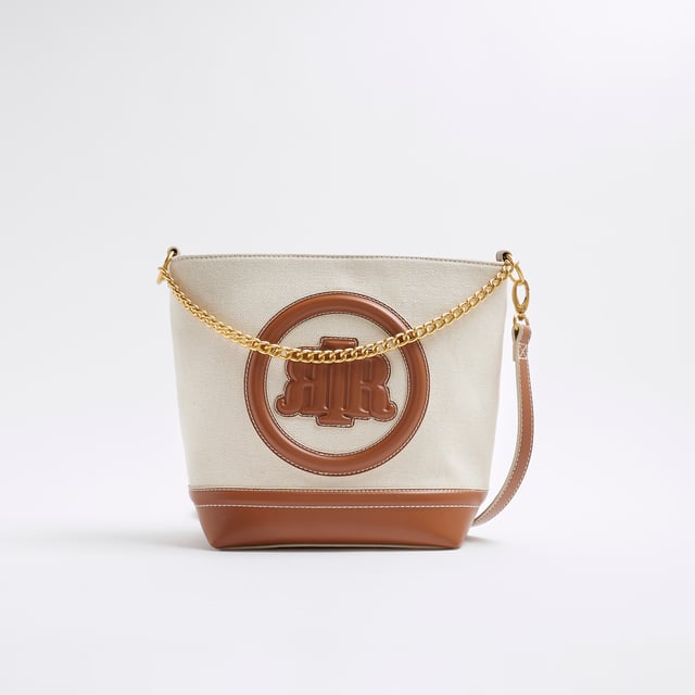 River Island Womens Cream Canvas Bucket Bag Canvas fabric, RR pendant, Lock detail, Stud pressed fastening, Grab handle, Bag dimension: H: 26cm x D: 12cm x W: 30cmAbout the brandFASHION IS OUR DNARiver Island is an icon of the British high street. Inspired by the latest trends and our heritage style archives, we've been serving style and leading trends for over sixty years.We make fashion for real people with real lives, who want to look real good. Because life's a celebration - let's dress for it.