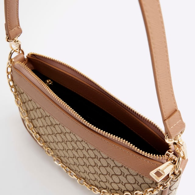 Jacquard fabric, RI monogram print, Grab handle, Adjustable strap, Zip fastening, Handle length: 22cm, Bag dimensions: H: 15.5cm x D: 4.5cm x W: 24cmAbout the brandFASHION IS OUR DNARiver Island is an icon of the British high street. Inspired by the latest trends and our heritage style archives, we've been serving style and leading trends for over sixty years.We make fashion for real people with real lives, who want to look real good. Because life's a celebration - let's dress for it.