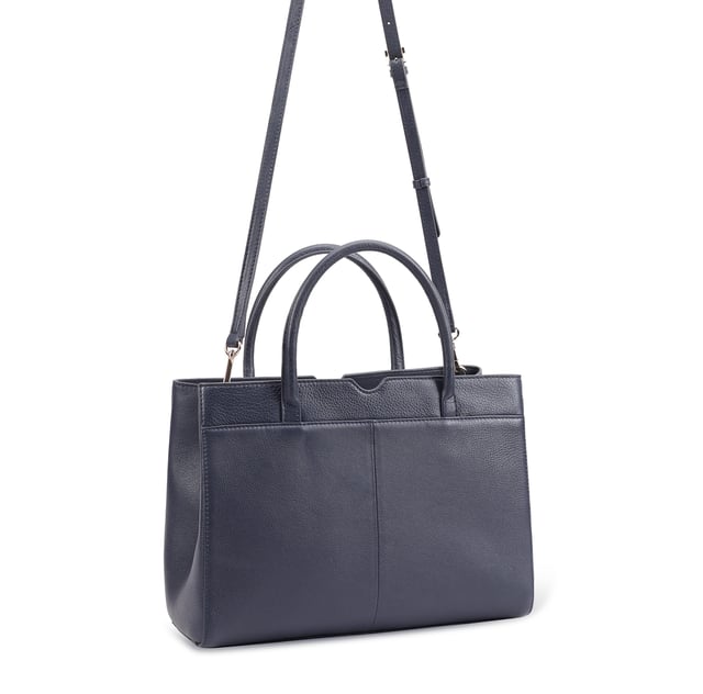 Made from soft premium leather, MAHAVY is a stylish work/travel bag is designed for both function and flair. It features two main compartments with a central zip section, all secured by a sleek magnetic tab. Inside, zipped and slip pockets on either side offer organized storageyou're your smaller essentials like keys, coin and phone. Complete with a removable, adjustable shoulder strap, it's a versatile and trendy companion for everyday use or travel. D:14.3cm W:33cm H:23.5cm