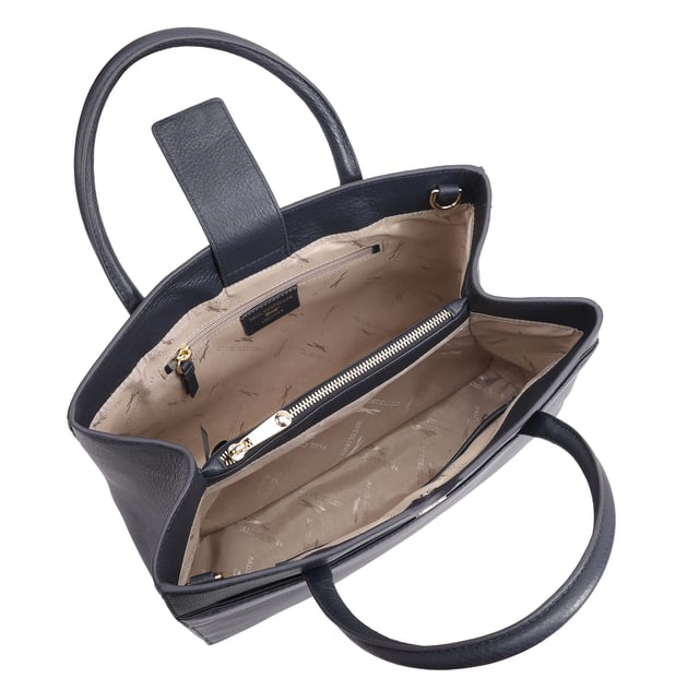 Made from soft premium leather, MAHAVY is a stylish work/travel bag is designed for both function and flair. It features two main compartments with a central zip section, all secured by a sleek magnetic tab. Inside, zipped and slip pockets on either side offer organized storageyou're your smaller essentials like keys, coin and phone. Complete with a removable, adjustable shoulder strap, it's a versatile and trendy companion for everyday use or travel. D:14.3cm W:33cm H:23.5cm
