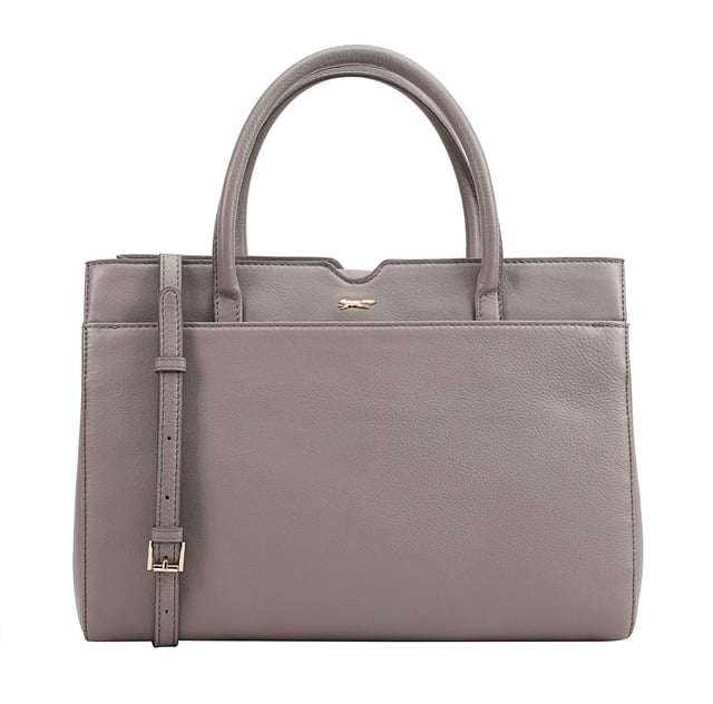 Made from soft premium leather, MAHAVY is a stylish work/travel bag is designed for both function and flair. It features two main compartments with a central zip section, all secured by a sleek magnetic tab. Inside, zipped and slip pockets on either side offer organized storageyou're your smaller essentials like keys, coin and phone. Complete with a removable, adjustable shoulder strap, it's a versatile and trendy companion for everyday use or travel. D:14.3cm W:33cm H:23.5cm