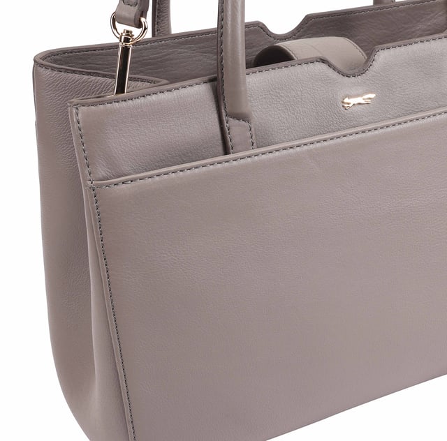 Made from soft premium leather, MAHAVY is a stylish work/travel bag is designed for both function and flair. It features two main compartments with a central zip section, all secured by a sleek magnetic tab. Inside, zipped and slip pockets on either side offer organized storageyou're your smaller essentials like keys, coin and phone. Complete with a removable, adjustable shoulder strap, it's a versatile and trendy companion for everyday use or travel. D:14.3cm W:33cm H:23.5cm