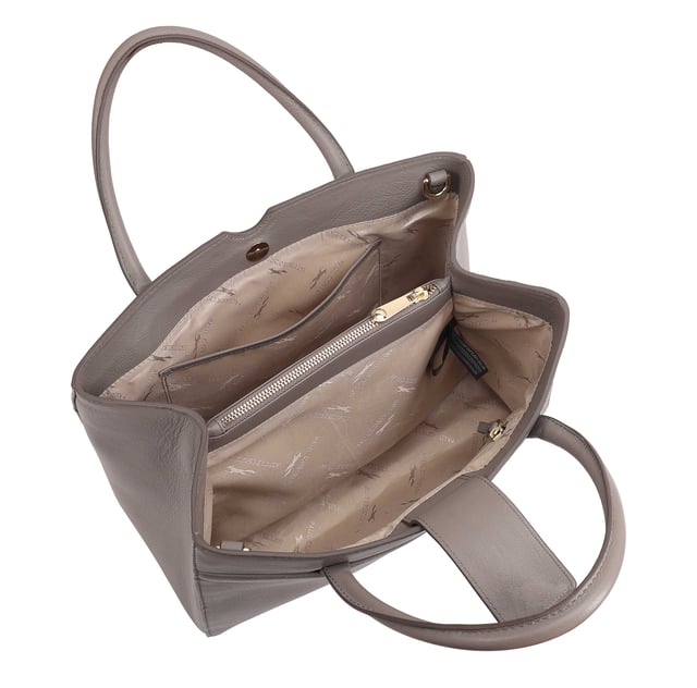Made from soft premium leather, MAHAVY is a stylish work/travel bag is designed for both function and flair. It features two main compartments with a central zip section, all secured by a sleek magnetic tab. Inside, zipped and slip pockets on either side offer organized storageyou're your smaller essentials like keys, coin and phone. Complete with a removable, adjustable shoulder strap, it's a versatile and trendy companion for everyday use or travel. D:14.3cm W:33cm H:23.5cm