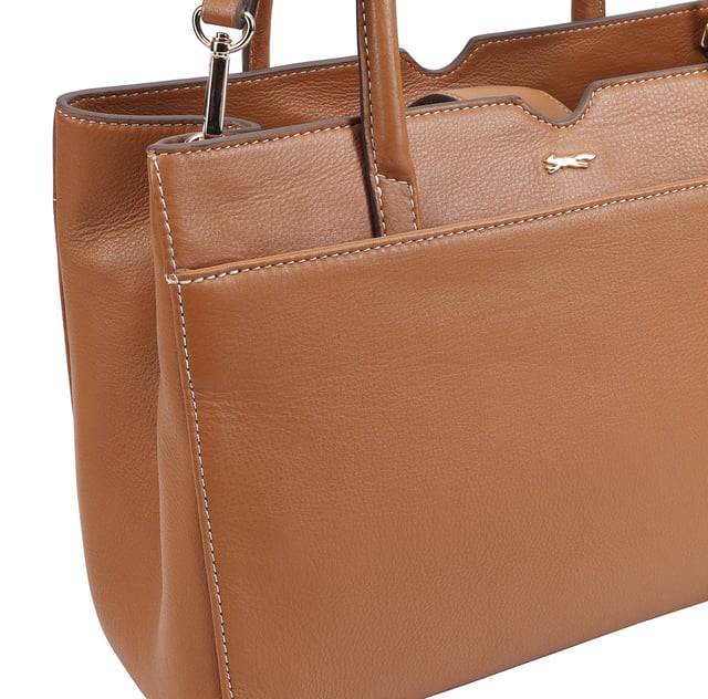 Made from soft premium leather, MAHAVY is a stylish work/travel bag is designed for both function and flair. It features two main compartments with a central zip section, all secured by a sleek magnetic tab. Inside, zipped and slip pockets on either side offer organized storageyou're your smaller essentials like keys, coin and phone. Complete with a removable, adjustable shoulder strap, it's a versatile and trendy companion for everyday use or travel. D:14.3cm W:33cm H:23.5cm