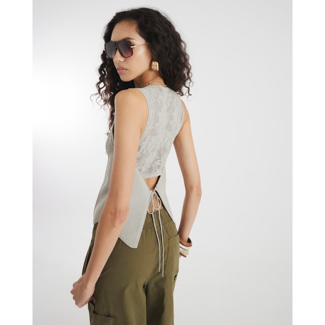 River Island Womens Waistcoat Grey Lace Back Crochet Crochet, V-neck, Sleeveless, Lace detail, Cut out back, Tie detail, Button fasteningAbout the brandFASHION IS OUR DNARiver Island is an icon of the British high street. Inspired by the latest trends and our heritage style archives, we've been serving style and leading trends for over sixty years.We make fashion for real people with real lives, who want to look real good. Because life's a celebration - let's dress for it.