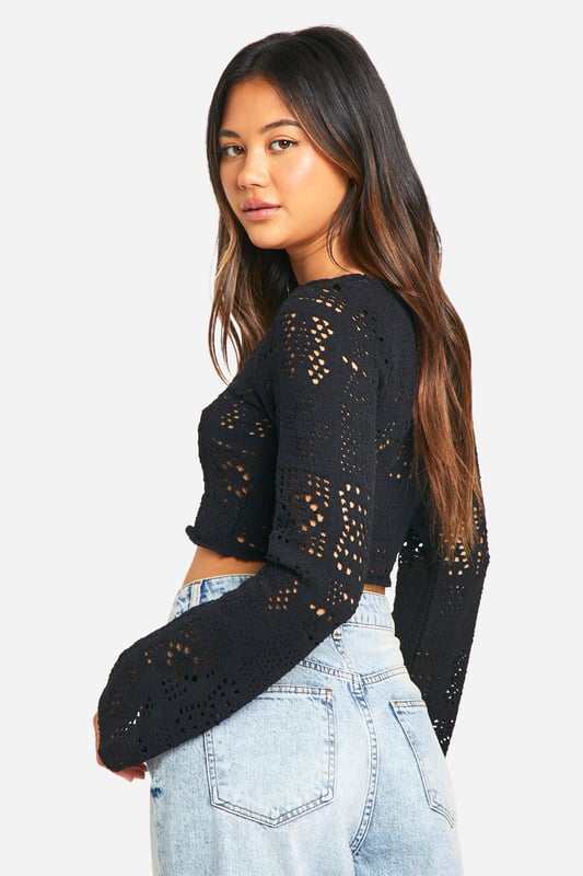 Intricate crochet-style pattern for a bold, eye-catching look
        Cropped length perfect for showcasing high-waisted bottoms
        Long sleeves with a slightly flared design
        Textured fabric adds depth and interest to the garment
        Versatile piece suitable for layering or wearing on its own
    
    This long-sleeved textured top is a must-have addition to your casual wardrobe. The intricate crochet-style pattern creates a captivating visual appeal, while the cropped silhouette adds a contemporary edge. Style it with high-waisted jeans and trainers for a laid-back daytime look, or pair it with a midi skirt and ankle boots for a chic evening ensemble. The versatility of this top makes it perfect for various casual occasions, from coffee dates to family gatherings. Layer it over a camisole on cooler days or wear it solo when the temperature rises. The slightly flared sleeves provide a subtle bohemian touch, making this top a standout piece that effortlessly combines comfort and style.