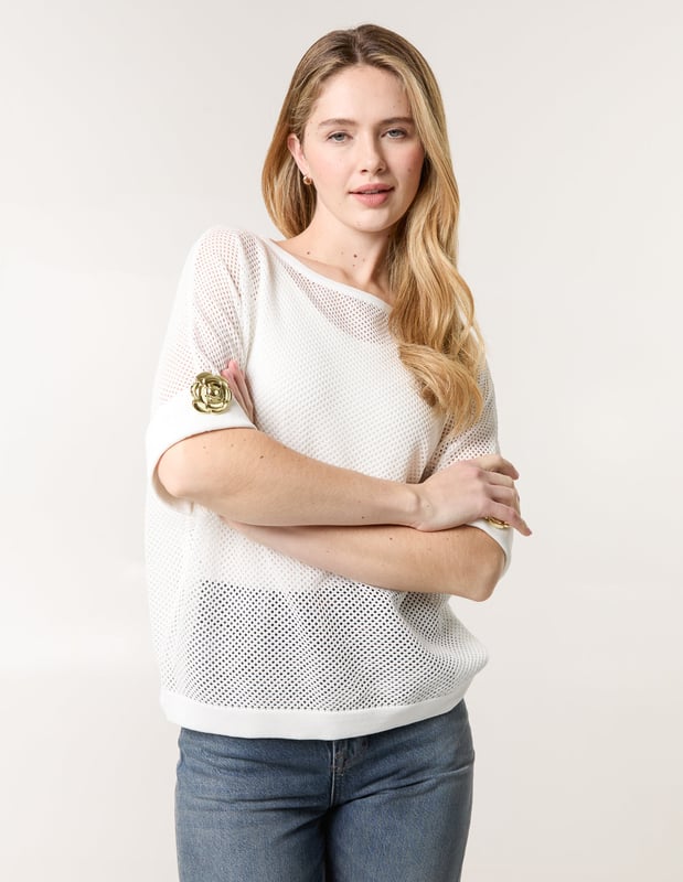 This crochet top is the perfect throw-on piece this season! With is cute gold flower detailing on the sleeves. Team with coloured denim jeans and gold sandals and accessories for the ultimate outfit!
