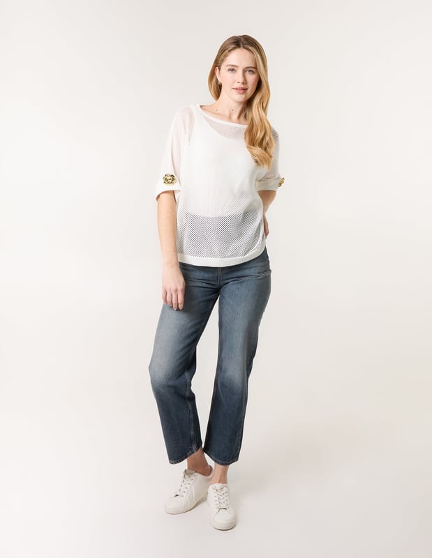 This crochet top is the perfect throw-on piece this season! With is cute gold flower detailing on the sleeves. Team with coloured denim jeans and gold sandals and accessories for the ultimate outfit!