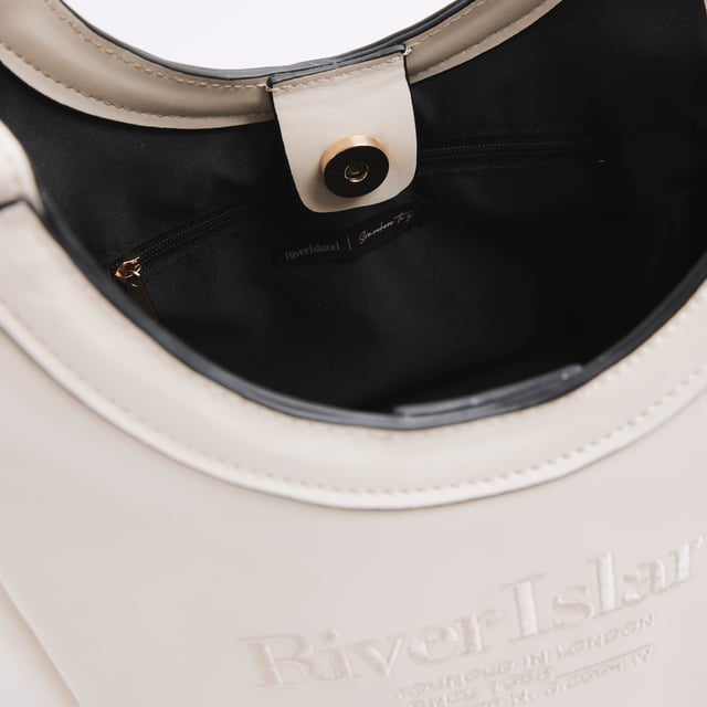 Faux leather fabric, Embossed branding, Side tie detail, Rounded handle, Popper fastening, Adjustable strap, Handle drop: 60cm, Bag dimensions: L: 20cm x D: 14cm x W: 22cmAbout the brandFASHION IS OUR DNARiver Island is an icon of the British high street. Inspired by the latest trends and our heritage style archives, we've been serving style and leading trends for over sixty years.We make fashion for real people with real lives, who want to look real good. Because life's a celebration - let's dress for it.