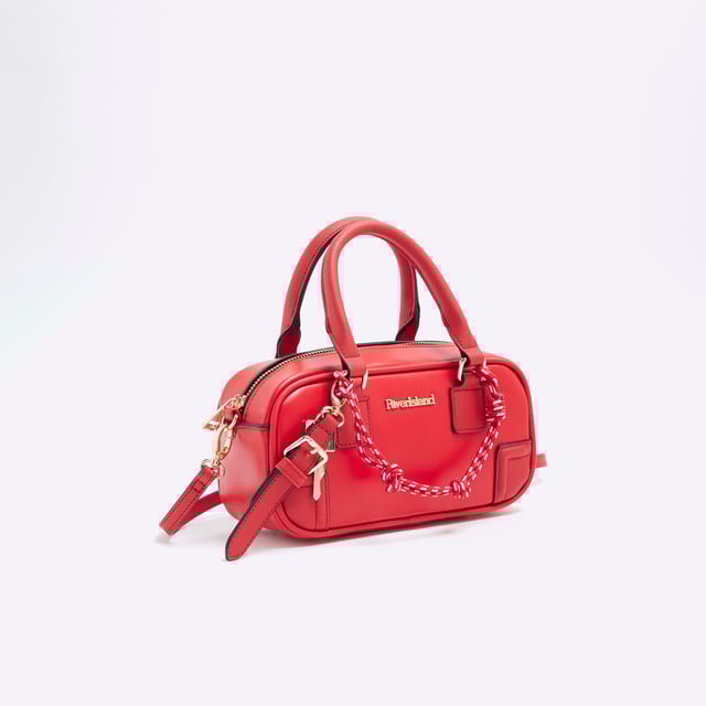 River Island Womens Red Faux Leather Charm Top Handle Bowler Bag Faux leather fabric, Adjustable strap, Grab handle, Zip fastening, Charm detail, Handle strap: 11cm x Strap drop: 60cm, Dimensions: H: 11cm x D: 7.5cm x W: 22.5cmAbout the brandFASHION IS OUR DNARiver Island is an icon of the British high street. Inspired by the latest trends and our heritage style archives, we've been serving style and leading trends for over sixty years.We make fashion for real people with real lives, who want to look real good. Because life's a celebration - let's dress for it.