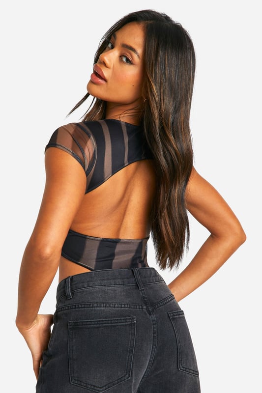 Striking vertical stripe pattern for a bold, eye-catching look
        Sheer mesh fabric adds a touch of allure and intrigue
        Daring cut-out back design for a sultry reveal
        Form-fitting silhouette accentuates curves
        Versatile bodysuit style for effortless pairing
    
    Make a statement on your next night out with this captivating cut-out back bodysuit from Boohoo. The vertical stripe pattern creates a visually elongating effect, while the sheer mesh fabric adds a tantalising touch of transparency. Perfect for the fashion-forward woman who loves to turn heads, this bodysuit can be styled multiple ways for various evening looks. Pair it with high-waisted wide-leg trousers and strappy heels for a chic club ensemble, or team it with a sleek midi skirt and statement earrings for cocktails with the girls. The versatile design allows for easy transition from day to night, making it an essential piece for the social butterfly who's always ready for her next adventure. Whether you're dancing the night away or enjoying drinks at a trendy rooftop bar, this bodysuit will ensure you're at the forefront of urban nightlife fashion.
