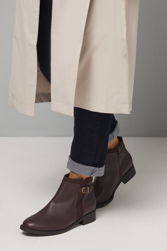 Good For The Sole: Wide Fit Mia Mixed Material Low Heel Ankle Boots Wide fit design ensures exceptional comfort for all-day wear
Decorative side buckle detail adds a subtle touch of sophistication
Mixed material construction combines different textures for visual interest
Flat heel measuring between 0-2cm provides stable support
Side zip closure allows for easy on-and-off access
The Mia Ankle Boots from Good For the Sole blend practicality with understated style. These versatile boots feature a clean silhouette with a distinctive side buckle that adds character without overwhelming the design. The wide fit construction ensures comfort for those who need a bit more room, whilst the flat heel provides stability for everyday activities. Style these faux leather boots with slim-fit trousers and an oversized jumper for casual weekend outings, or pair with tights and a midi skirt for a more polished daytime look. Perfect for autumn strolls, family gatherings or casual coffee dates, these boots will quickly become your go-to footwear choice. Their neutral aesthetic makes them incredibly adaptable to various outfits, whilst the durable construction ensures they'll withstand the demands of daily wear throughout the changing seasons.