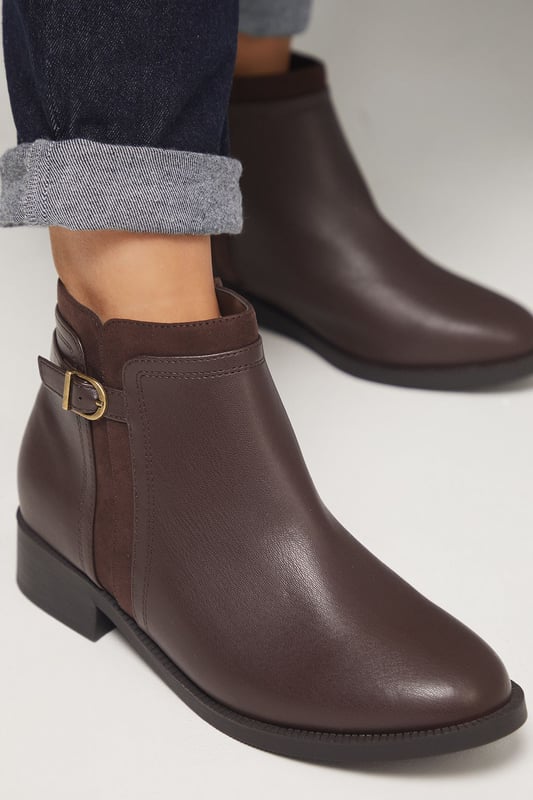Good For The Sole: Wide Fit Mia Mixed Material Low Heel Ankle Boots Wide fit design ensures exceptional comfort for all-day wear
Decorative side buckle detail adds a subtle touch of sophistication
Mixed material construction combines different textures for visual interest
Flat heel measuring between 0-2cm provides stable support
Side zip closure allows for easy on-and-off access
The Mia Ankle Boots from Good For the Sole blend practicality with understated style. These versatile boots feature a clean silhouette with a distinctive side buckle that adds character without overwhelming the design. The wide fit construction ensures comfort for those who need a bit more room, whilst the flat heel provides stability for everyday activities. Style these faux leather boots with slim-fit trousers and an oversized jumper for casual weekend outings, or pair with tights and a midi skirt for a more polished daytime look. Perfect for autumn strolls, family gatherings or casual coffee dates, these boots will quickly become your go-to footwear choice. Their neutral aesthetic makes them incredibly adaptable to various outfits, whilst the durable construction ensures they'll withstand the demands of daily wear throughout the changing seasons.