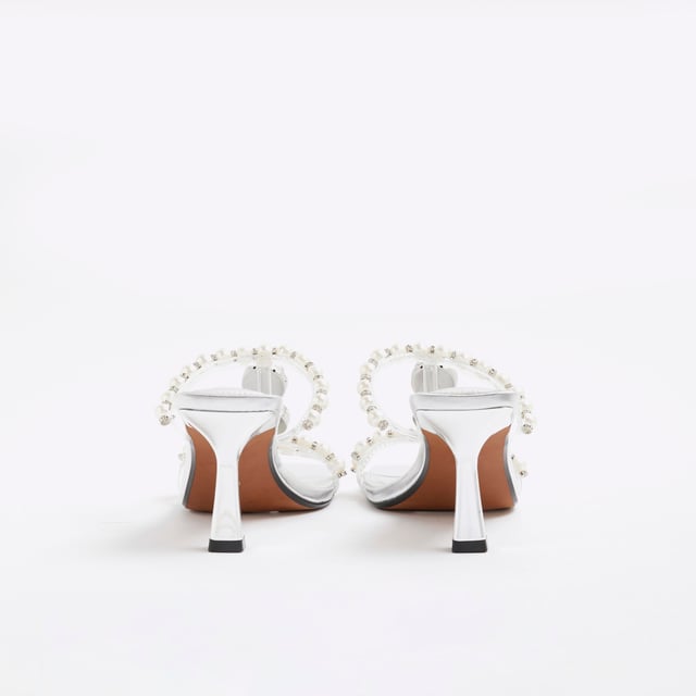 River Island Womens Sandals Silver Pearl Diamante Heeled Faux leather fabric, Pearl detail, Diamante detail, Open toe, Backless, Skinny heels, Heel height: 6cmAbout the brandFASHION IS OUR DNARiver Island is an icon of the British high street. Inspired by the latest trends and our heritage style archives, we've been serving style and leading trends for over sixty years.We make fashion for real people with real lives, who want to look real good. Because life's a celebration - let's dress for it.