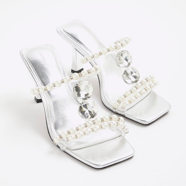 River Island Womens Sandals Silver Pearl Diamante Heeled Faux leather fabric, Pearl detail, Diamante detail, Open toe, Backless, Skinny heels, Heel height: 6cmAbout the brandFASHION IS OUR DNARiver Island is an icon of the British high street. Inspired by the latest trends and our heritage style archives, we've been serving style and leading trends for over sixty years.We make fashion for real people with real lives, who want to look real good. Because life's a celebration - let's dress for it.