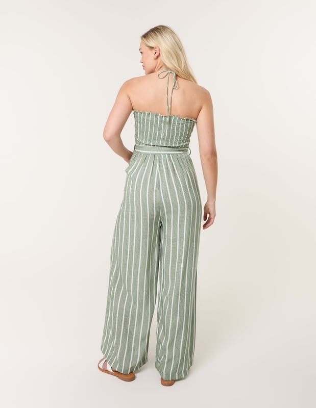 A timeless addition to your wardrobe, perfectly teamed with woven sandals, making this pinstripe jumpsuit a sustainable clothing choice that will stand the test of time.